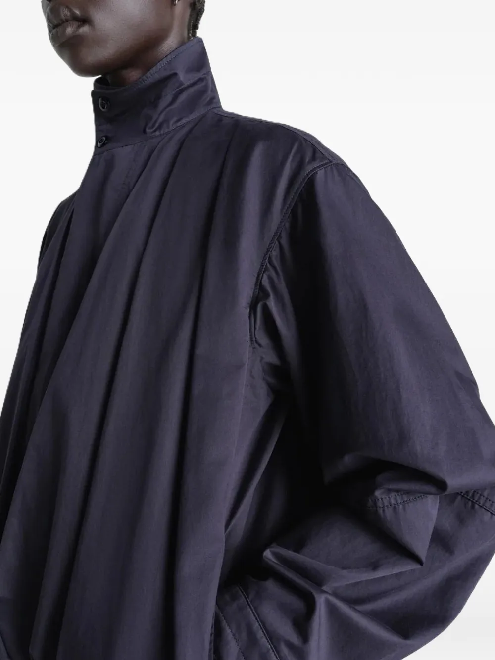 Close up of navy jackets-coats, showing texture of the cotton fabric