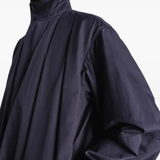 Close up of navy jackets-coats, showing texture of the cotton fabric