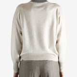 Grey knitwear worn by a person, showing the knitwear fit