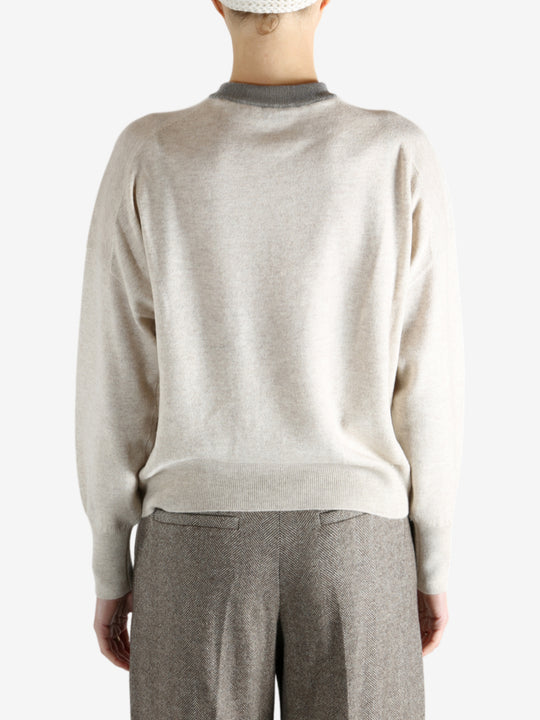 Grey knitwear worn by a person, showing the knitwear fit