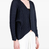 Navy knitwear worn by a person, showing the knitwear fit