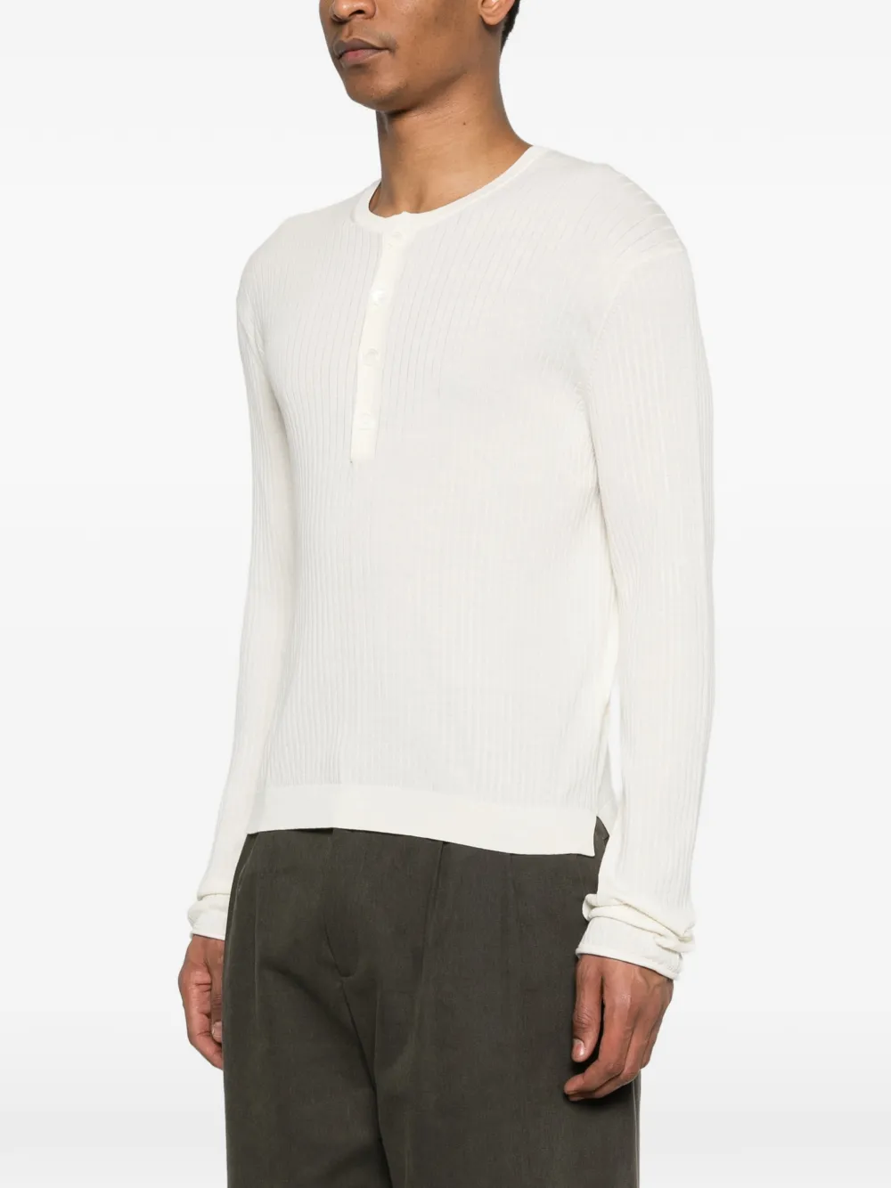 White knitwear worn by a person, showing the knitwear fit