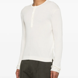 White knitwear worn by a person, showing the knitwear fit