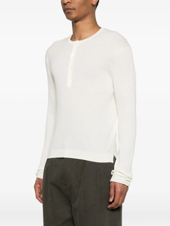 White knitwear worn by a person, showing the knitwear fit
