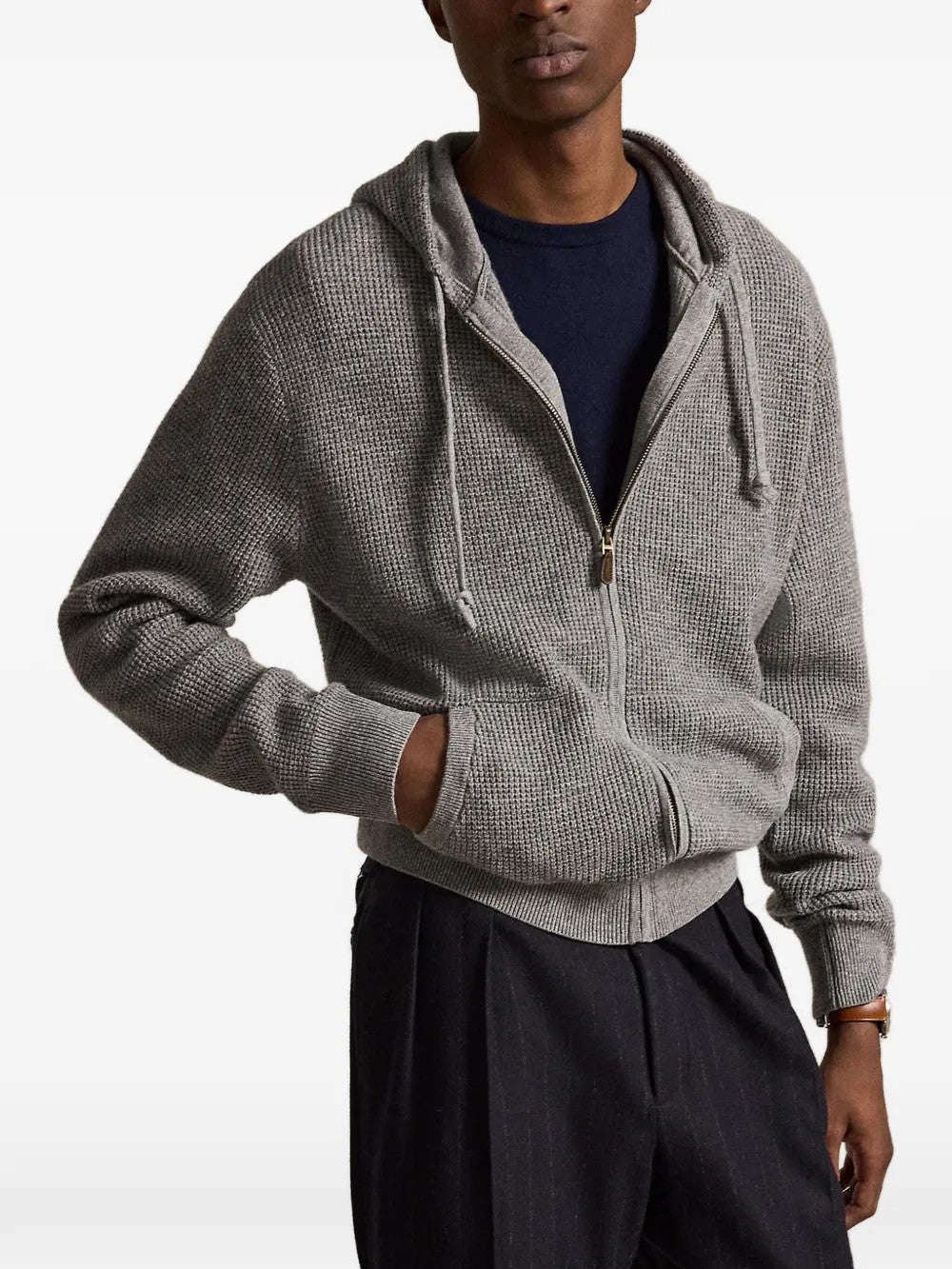 Grey knitwear worn by a person, showing the knitwear fit