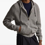 Grey knitwear worn by a person, showing the knitwear fit