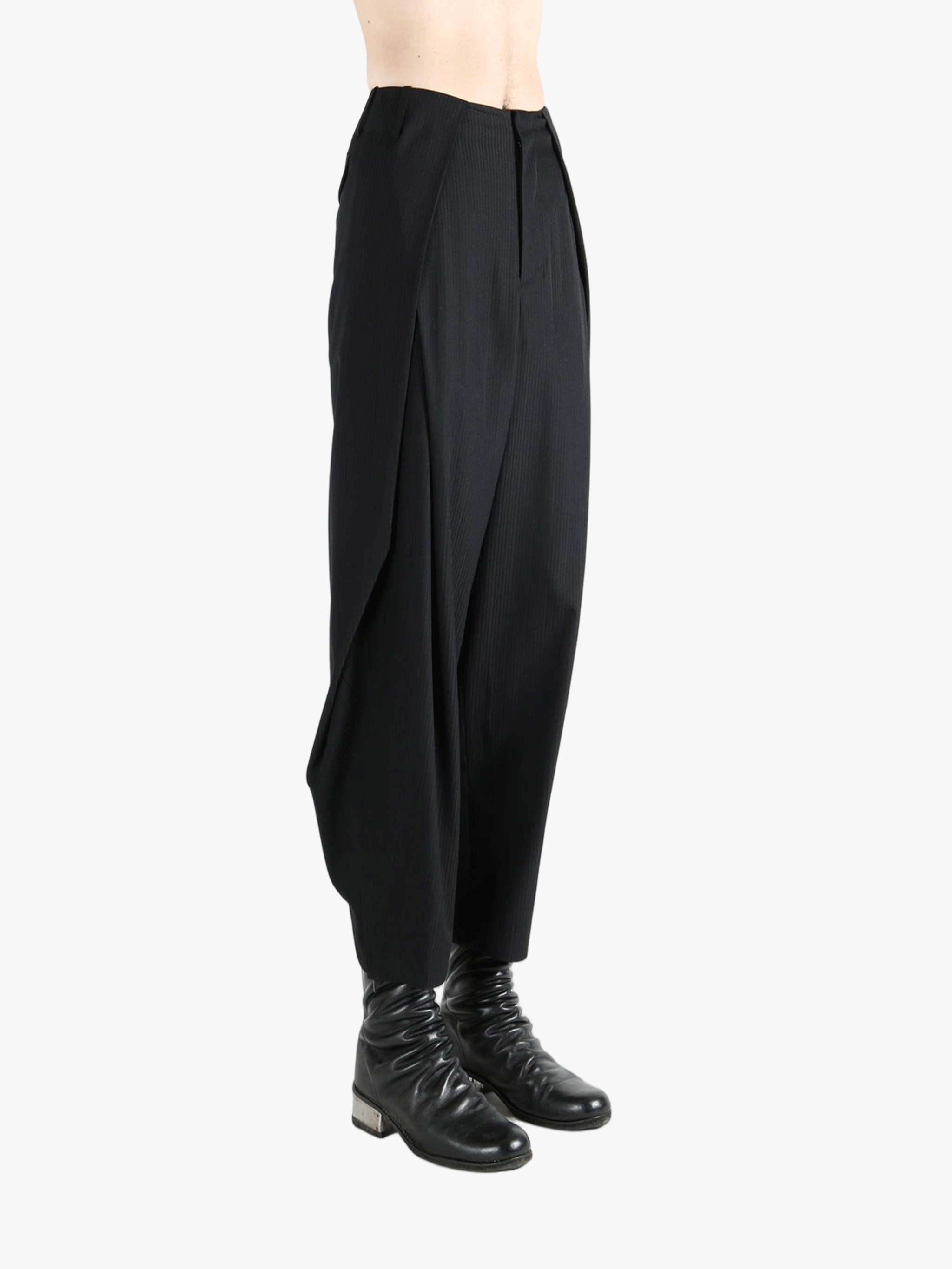 Black pants worn by a person, showing the pants's fit