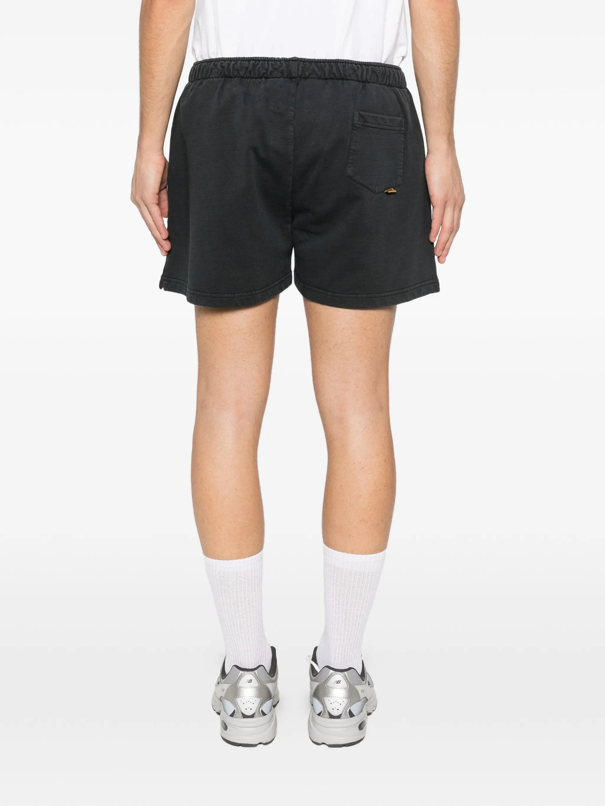Black shorts worn by a person, showing the pants's fit