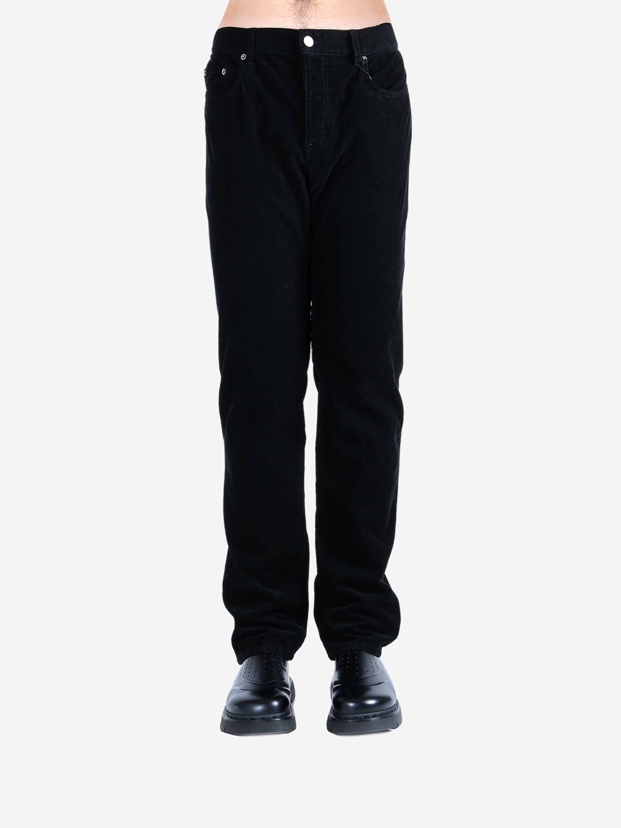 Black pants worn by a person, showing the pants's fit