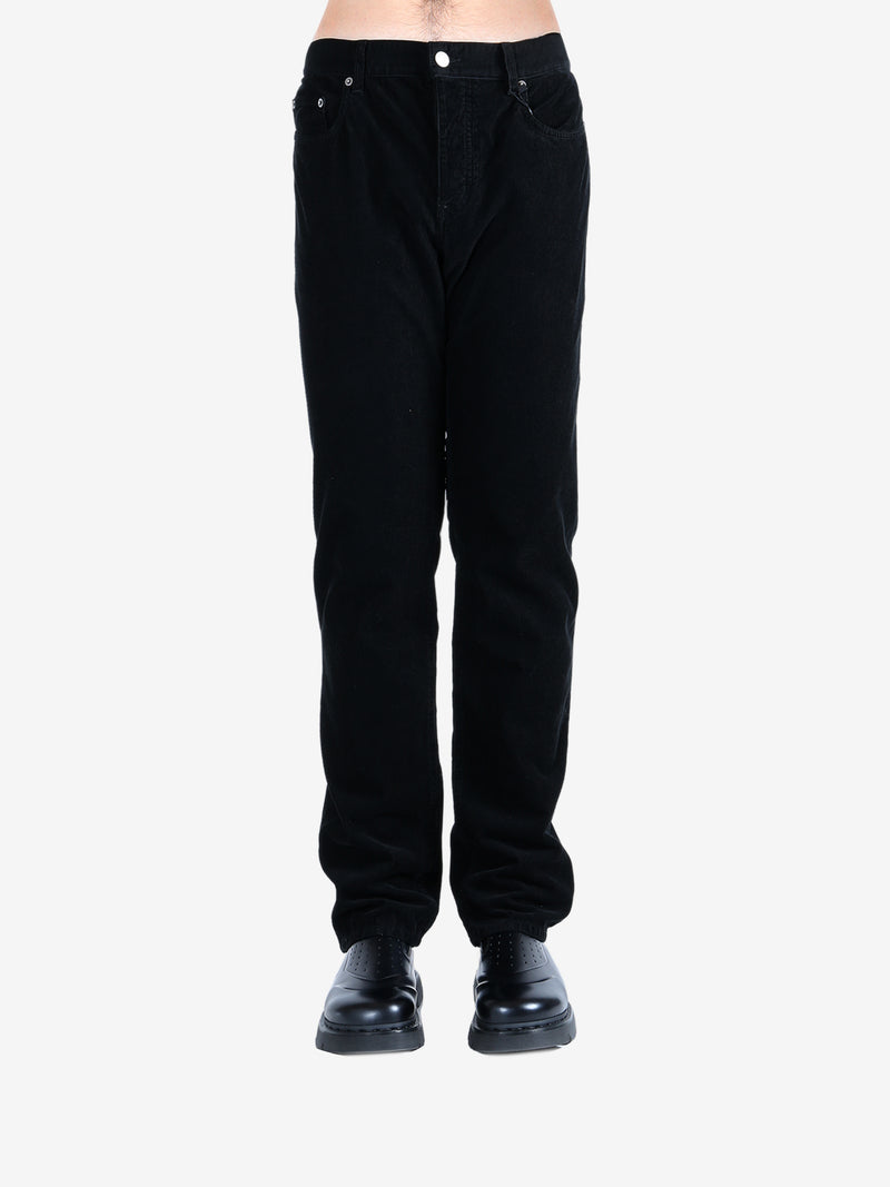Black pants worn by a person, showing the pants's fit