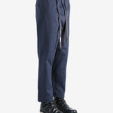 Navy pants worn by a person, showing the pants's fit