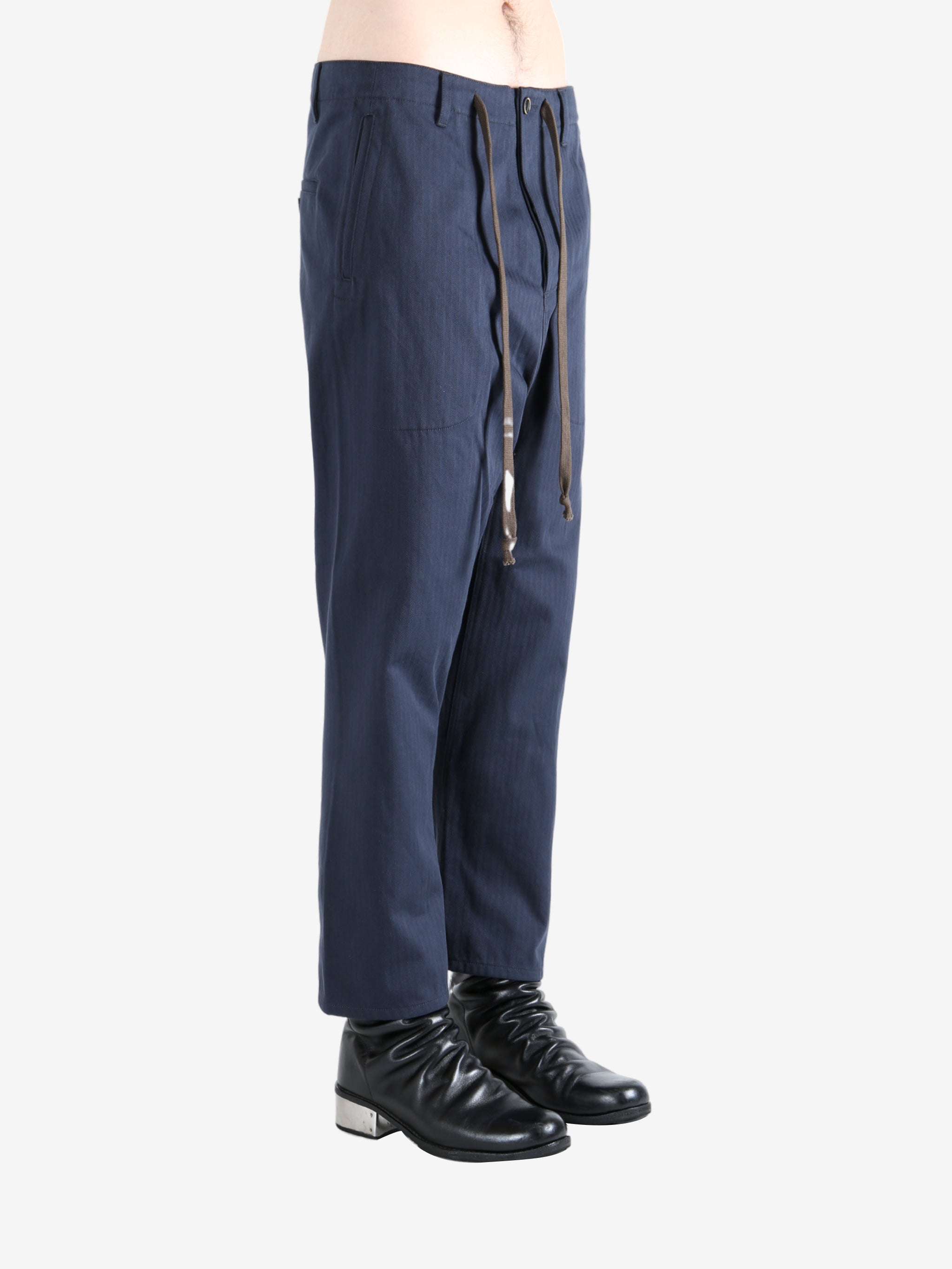 Navy pants worn by a person, showing the pants's fit
