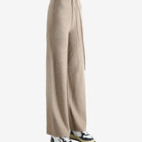 Beige pants worn by a person, showing the pants fit