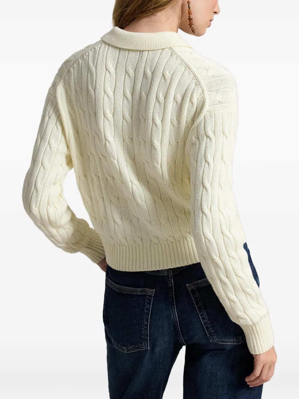 Tan knitwear worn by a person, showing the knitwear fit