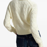 Tan knitwear worn by a person, showing the knitwear fit