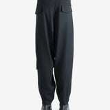 Black pants worn by a person, showing the pants's fit