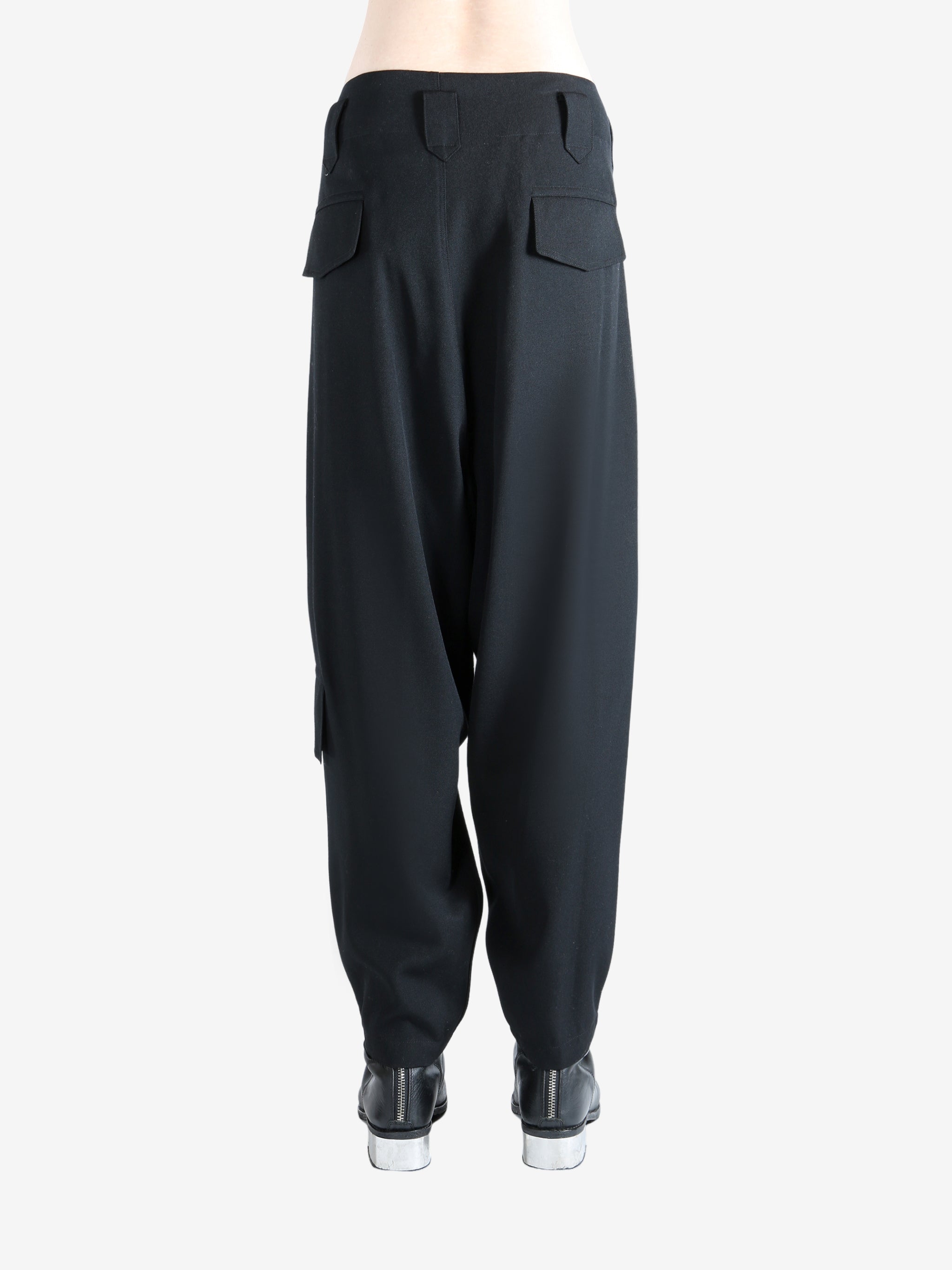 Black pants worn by a person, showing the pants's fit