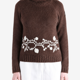 Brown knitwear worn by a person, showing the knitwear fit