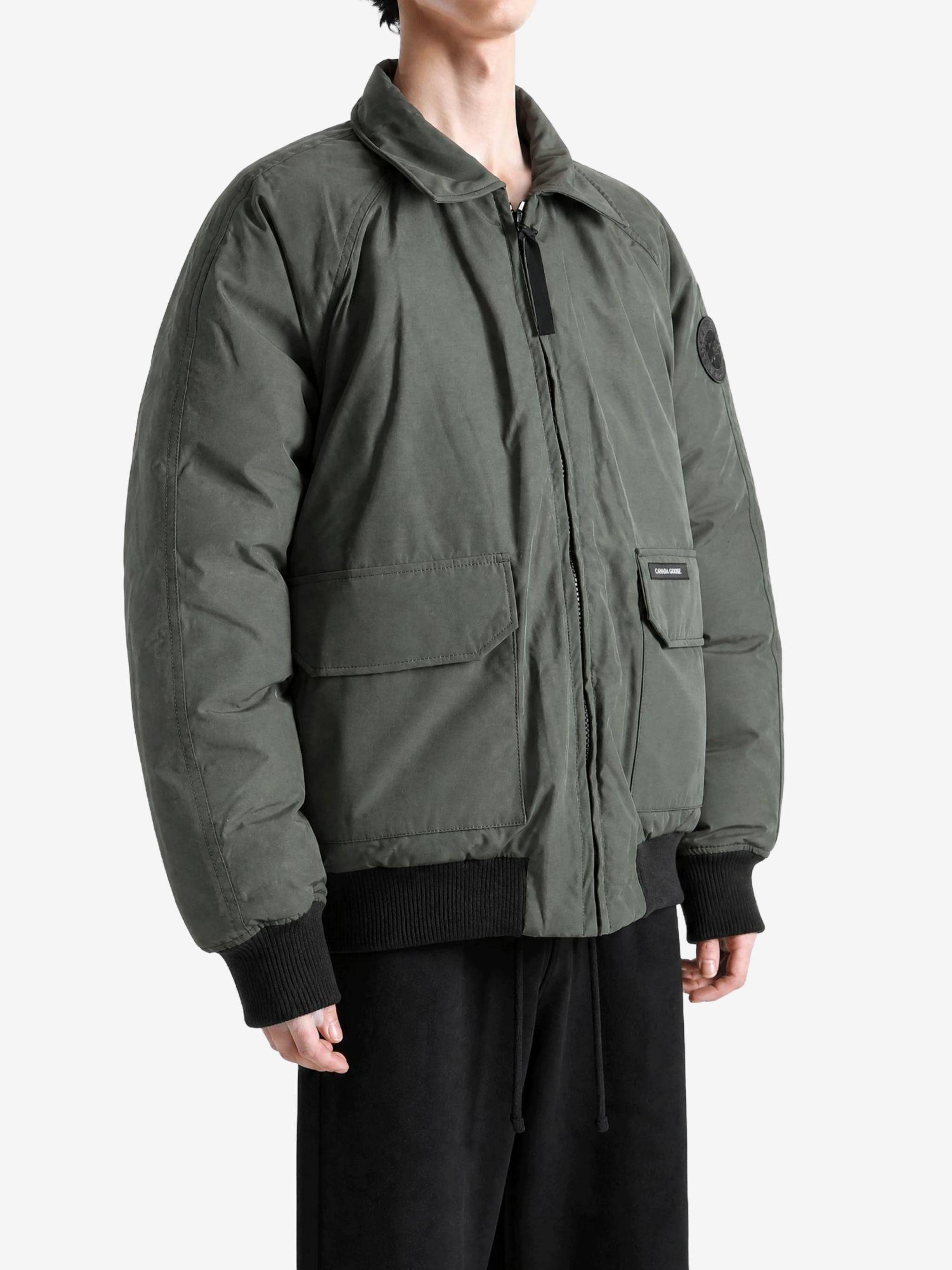 Green jacket worn by a person, showing the jacket fit