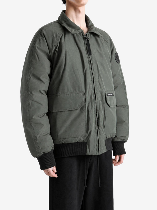 Green jacket worn by a person, showing the jacket fit