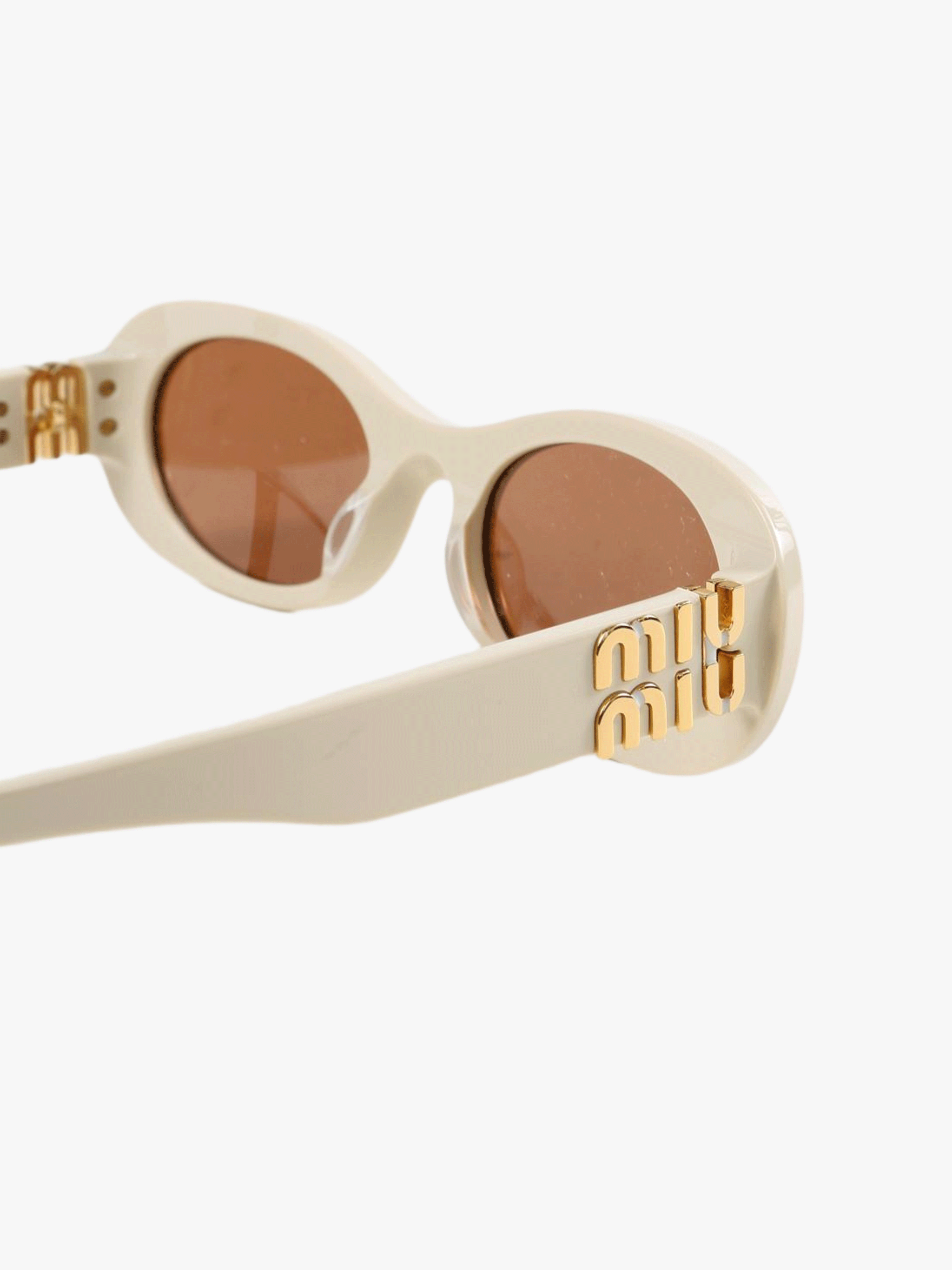 Close up of the brown sunglasses, showing texture of the acetate fabric
