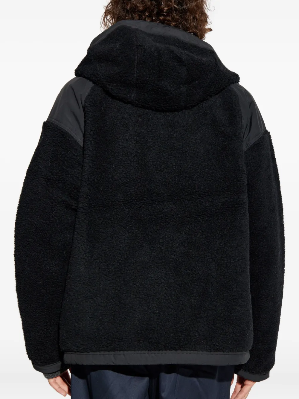 Black jacket worn by a person, showing the jacket fit