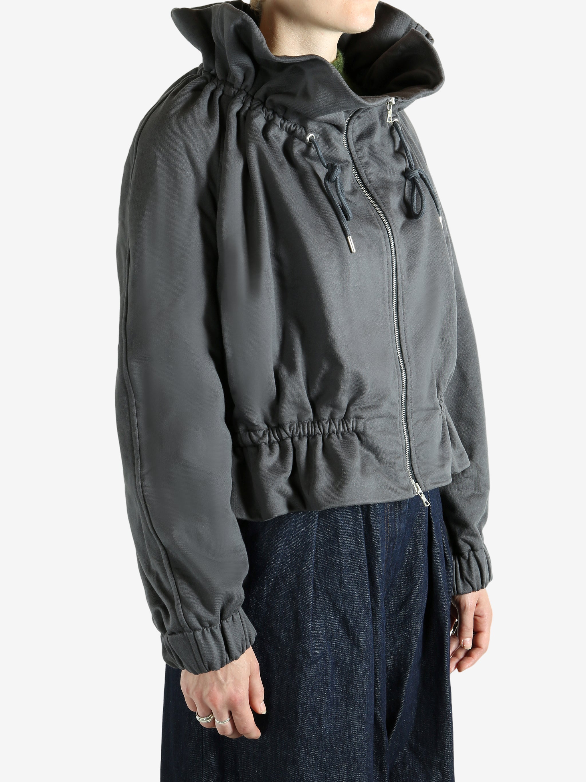 Grey jacket worn by a person, showing the jacket's fit