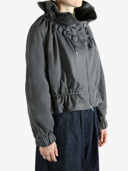 Grey jacket worn by a person, showing the jacket's fit