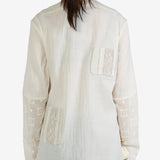 White shirt worn by a person, showing the shirt's fit