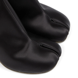 Close up of black boots, showing texture of the leather fabric