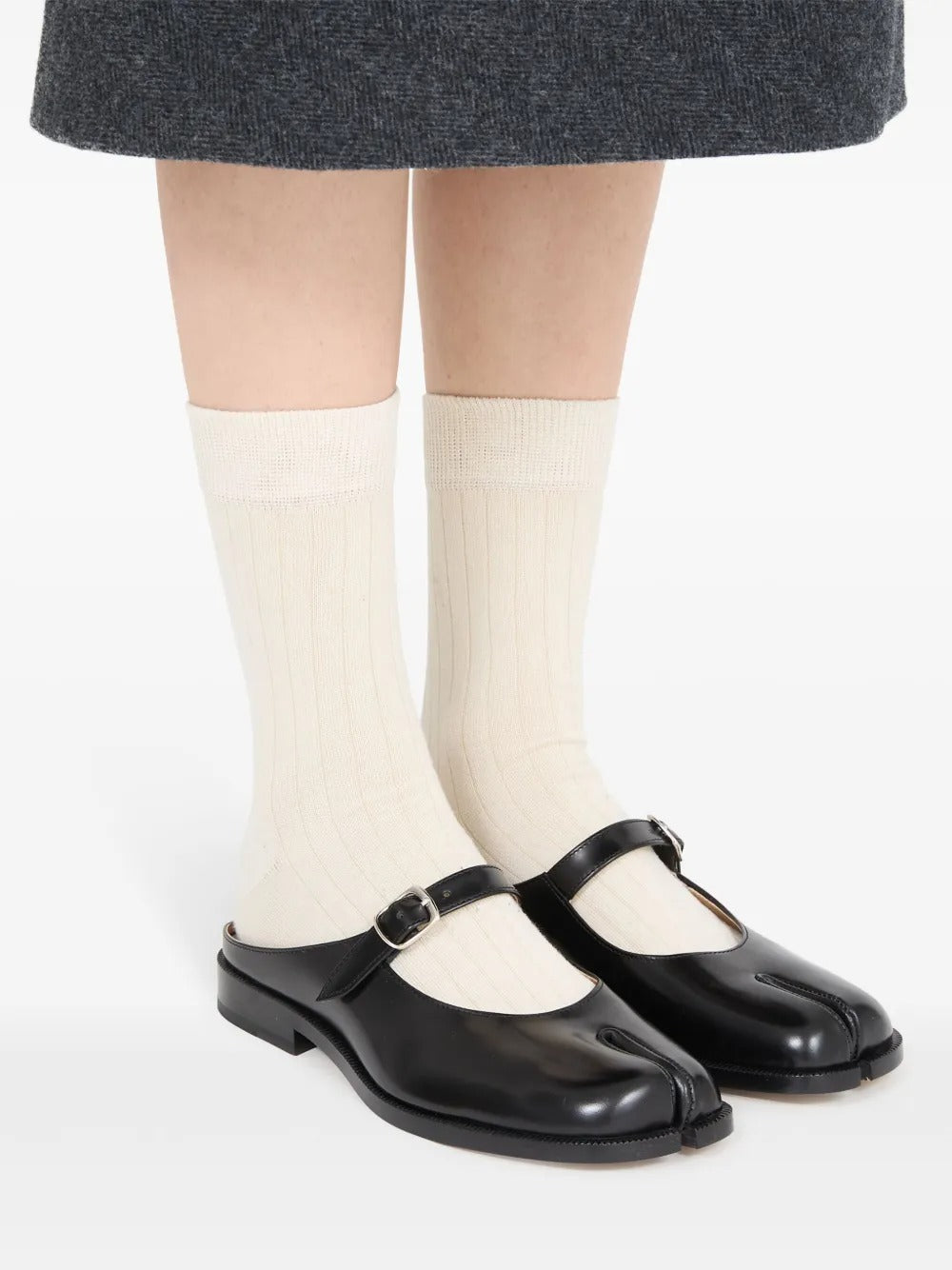 Black mule worn by a person, showing the mule's fit