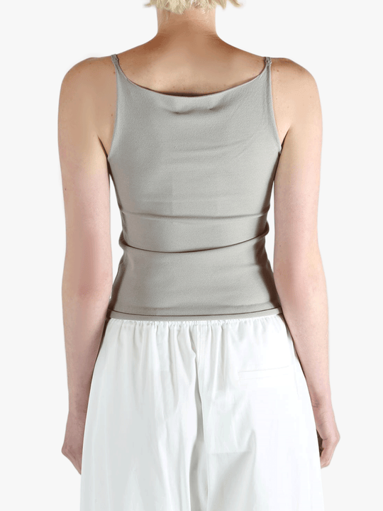 Grey tops worn by a person, showing the tops fit