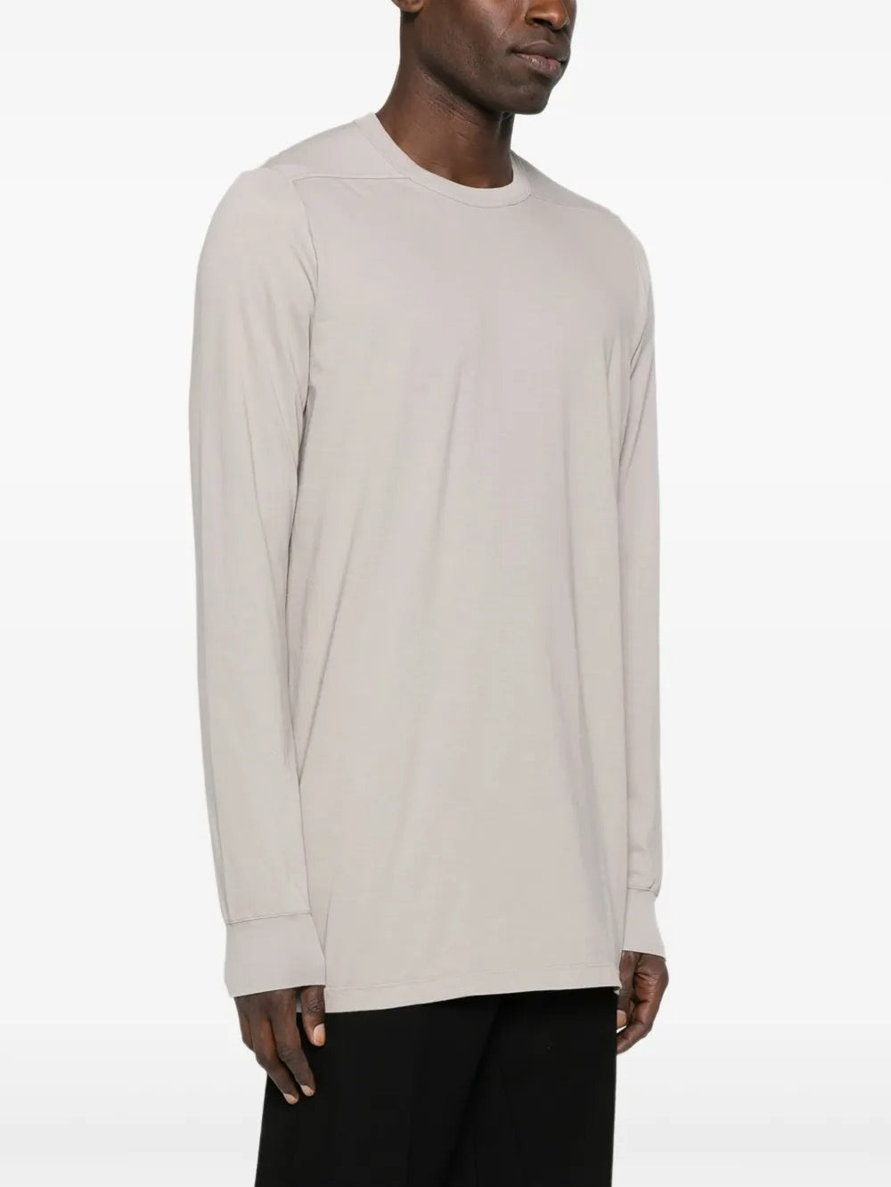 White t-shirt worn by a person, showing the shirt's fit