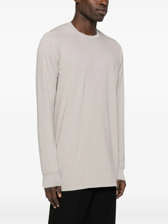 White t-shirt worn by a person, showing the shirt's fit