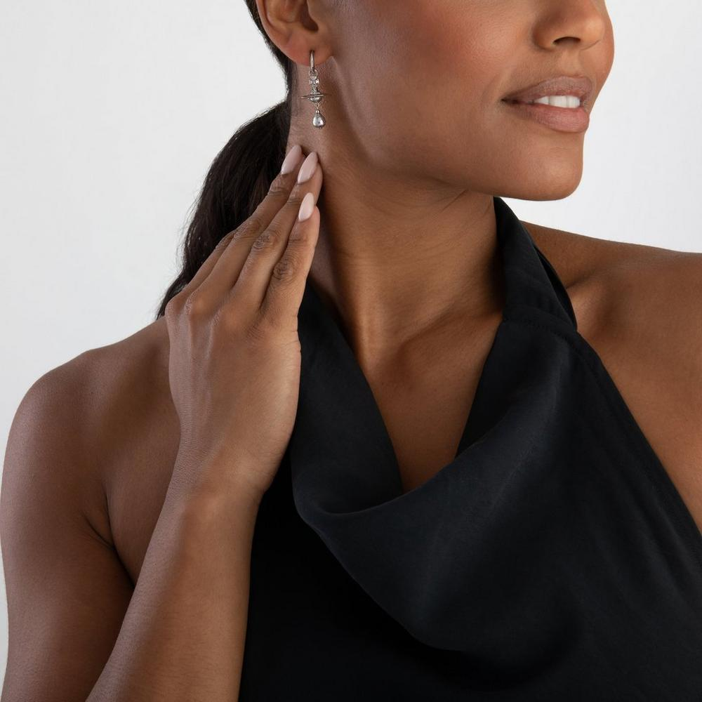 Purple jewelry worn by a person, showing the jewelry fit