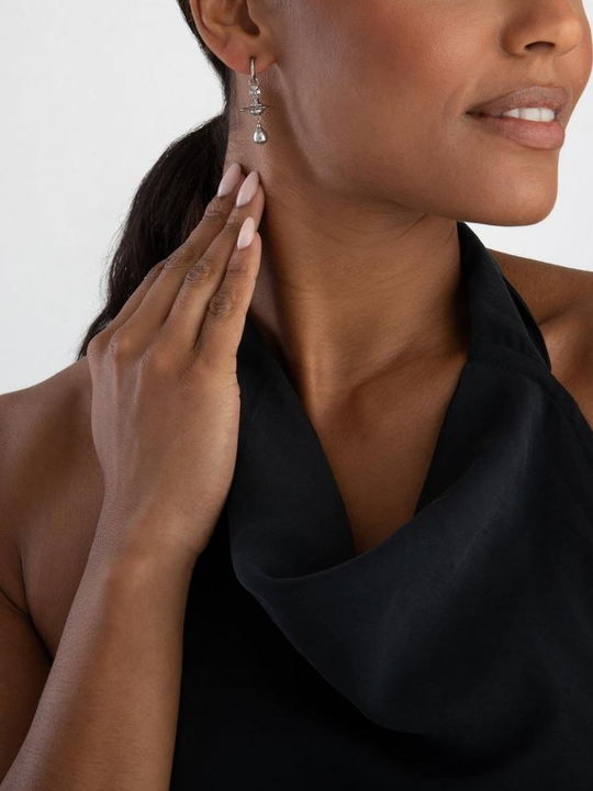 Purple jewelry worn by a person, showing the jewelry fit