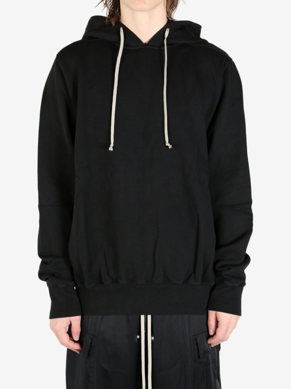 Black hoodie worn by a person, showing the hoodie's fit
