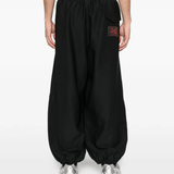 Black pants worn by a person, showing the pants fit