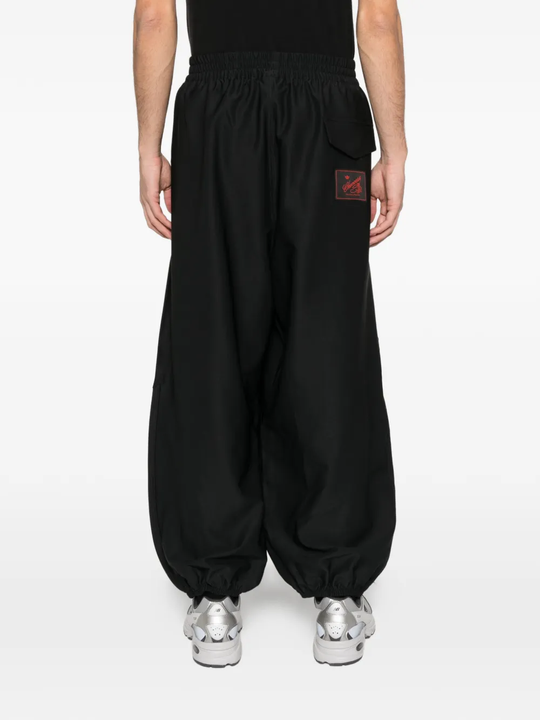 Black pants worn by a person, showing the pants fit