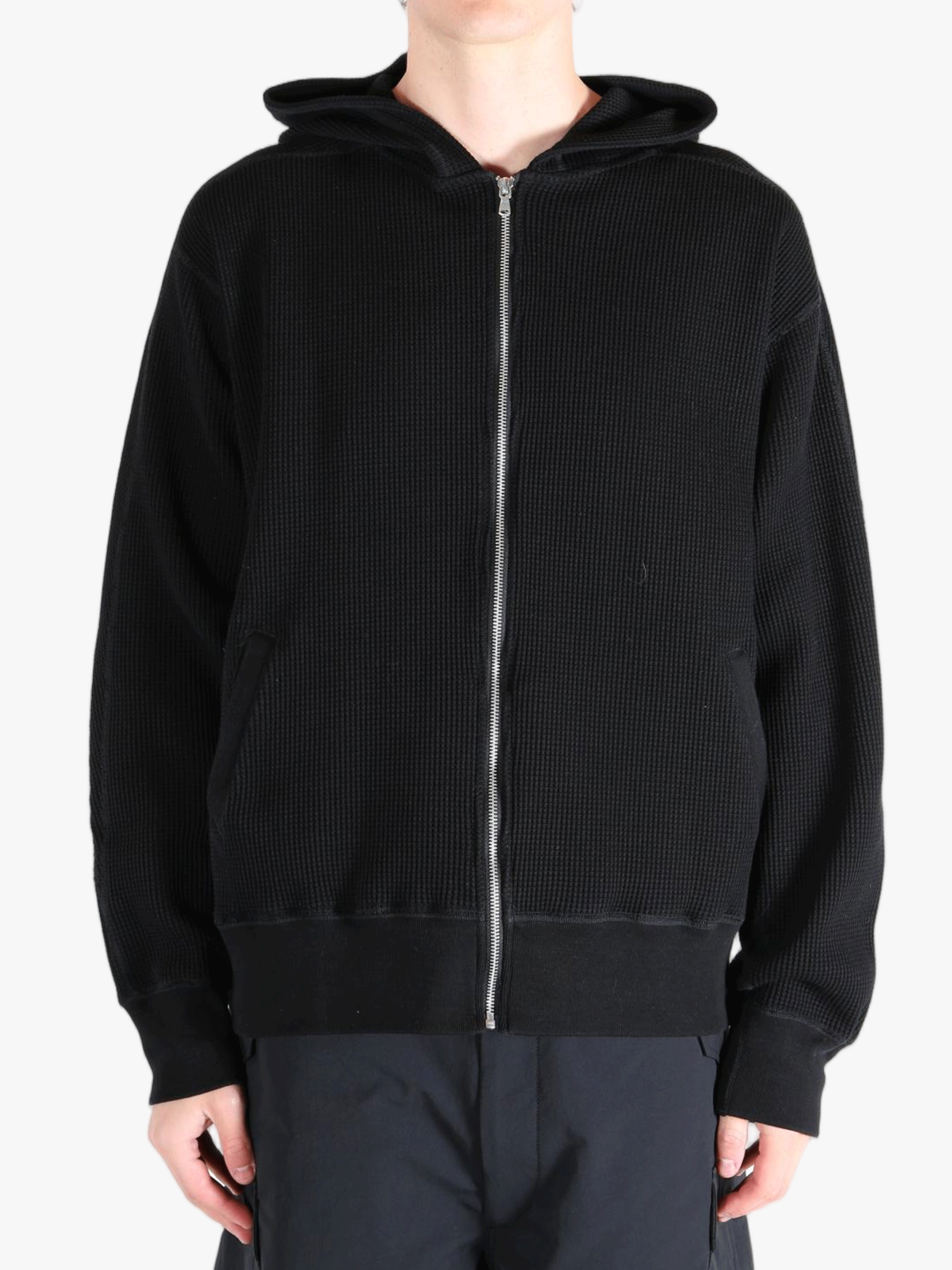 Black hoodie worn by a person, showing the hoodie's fit