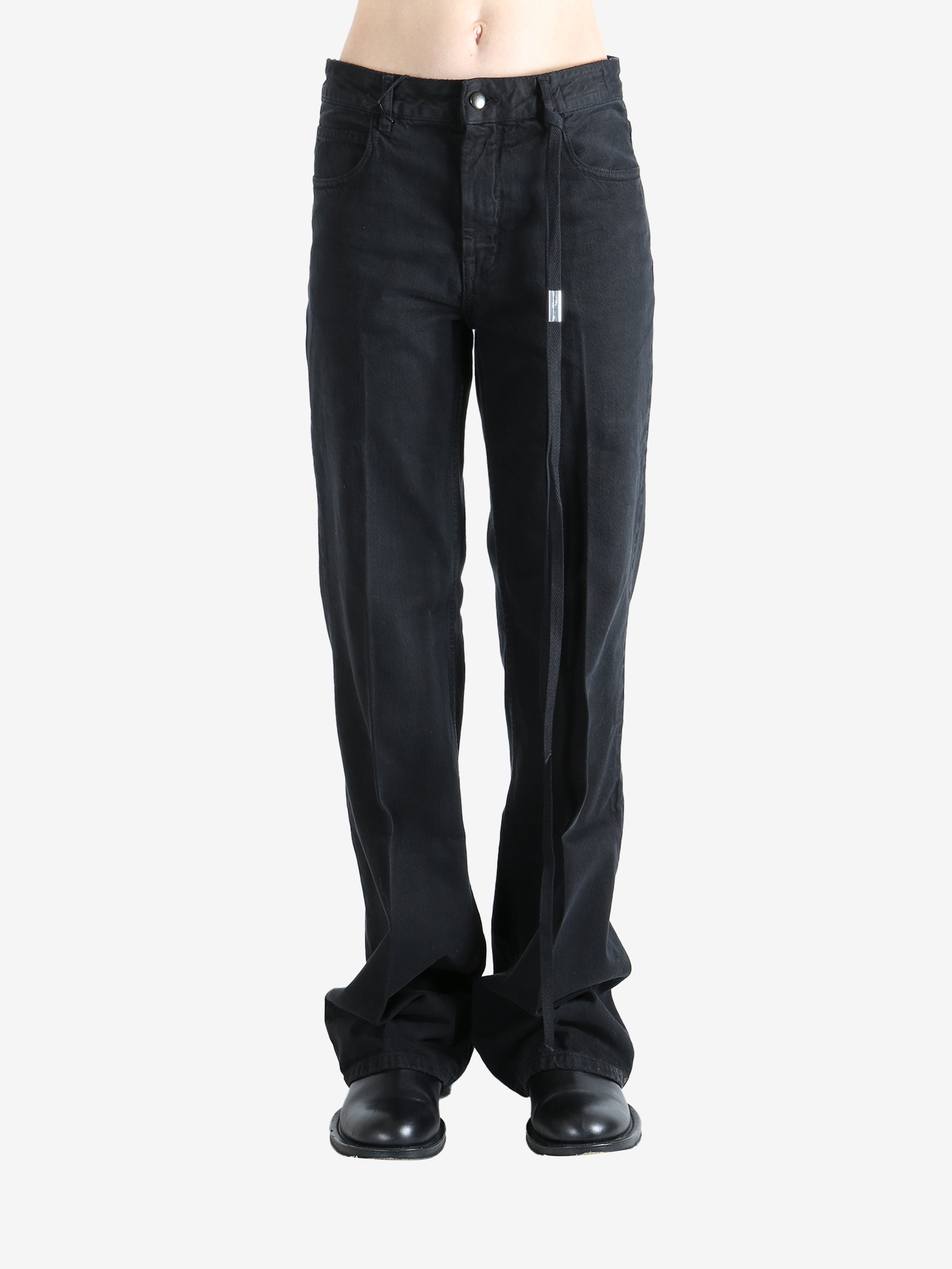 Black pants worn by a person, showing the pants' fit