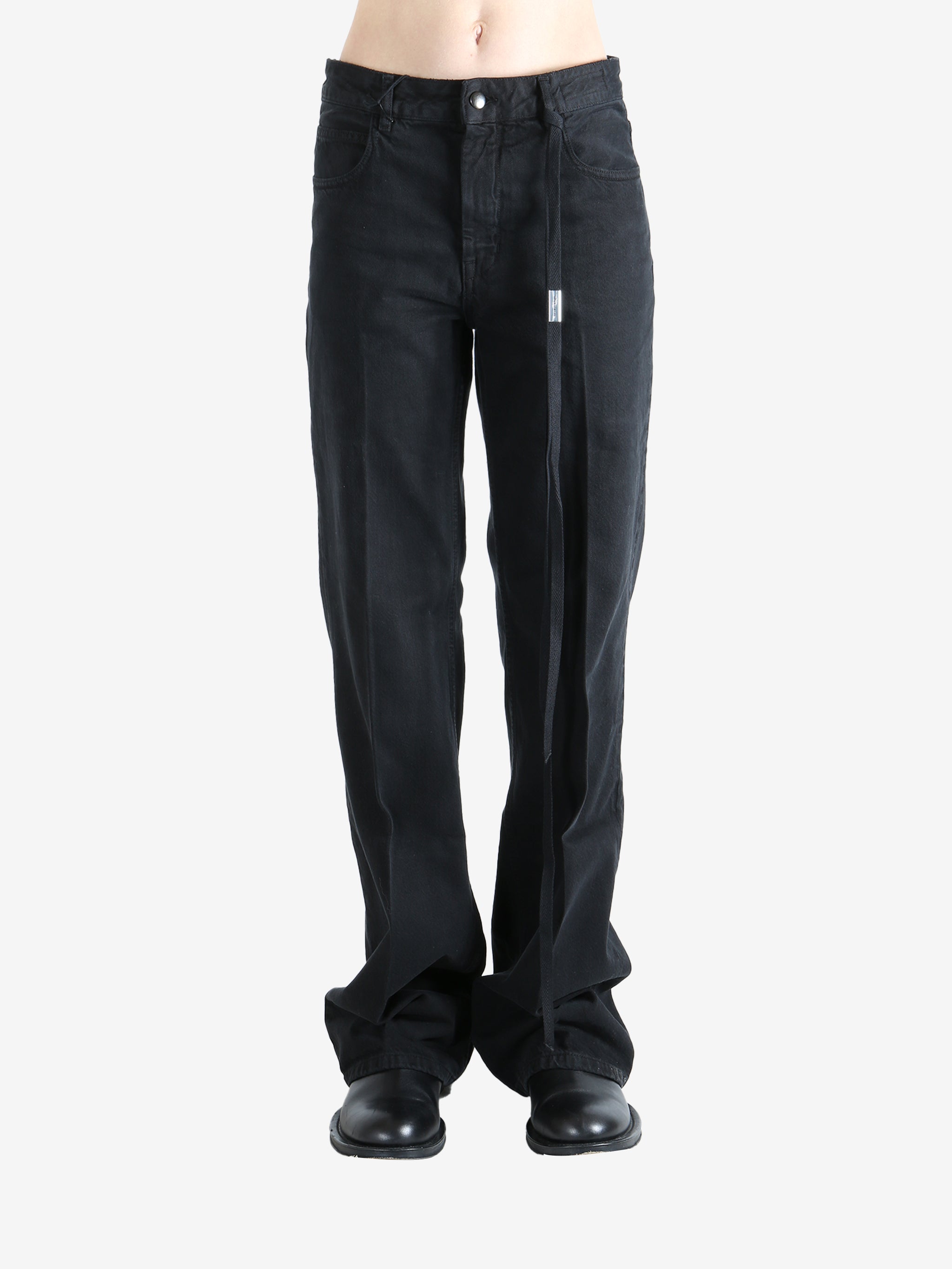 Black pants worn by a person, showing the pants' fit