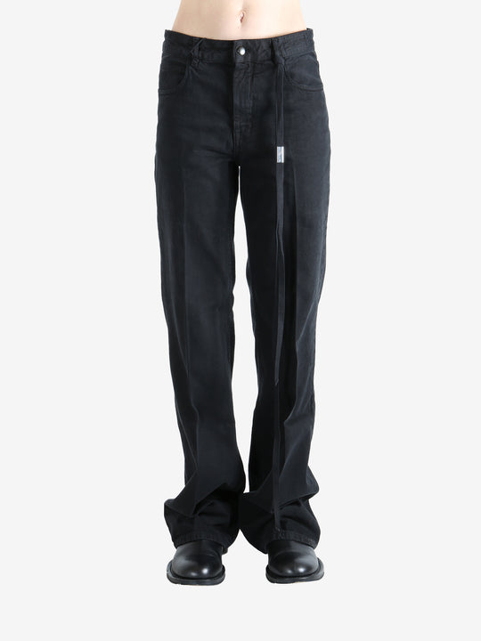 Black pants worn by a person, showing the pants' fit