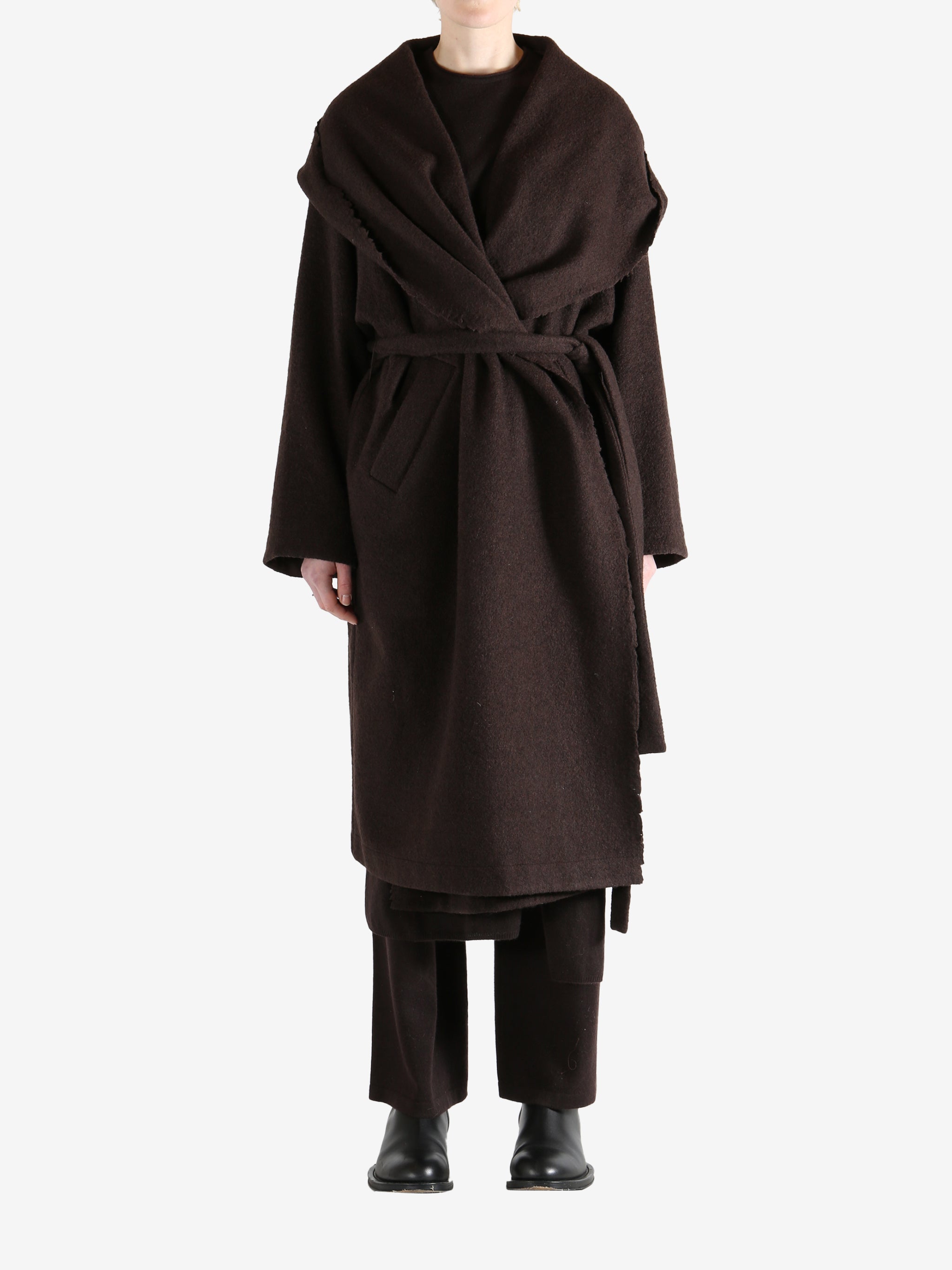 Brown coat worn by a person, showing the coat fit