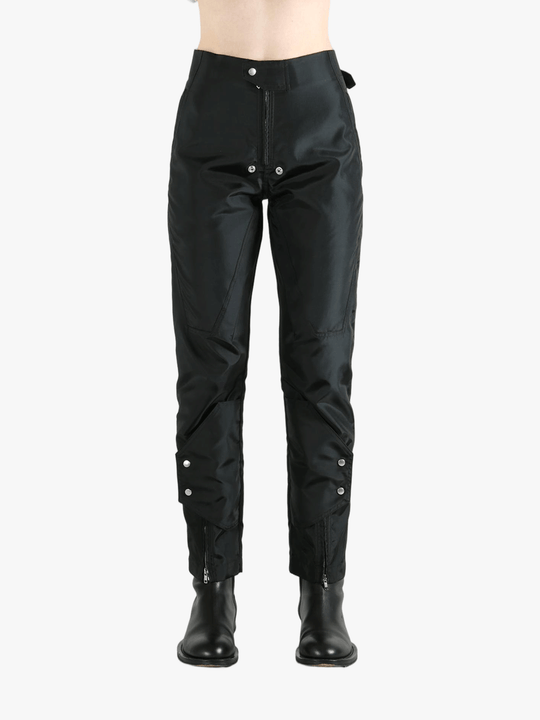 Black pants worn by a person, showing the pants' fit