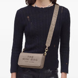 Tan bags worn by a person, showing the bags fit