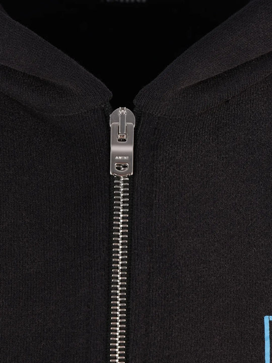 Close up of the black hoodie, showing texture of the cotton fabric