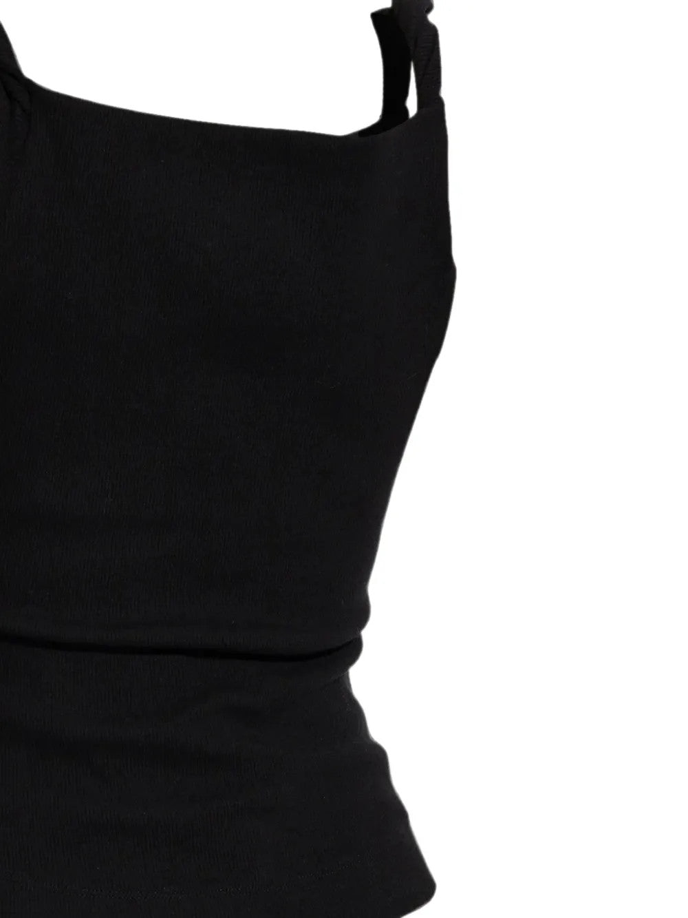 Black top worn by a person, showing the top fit