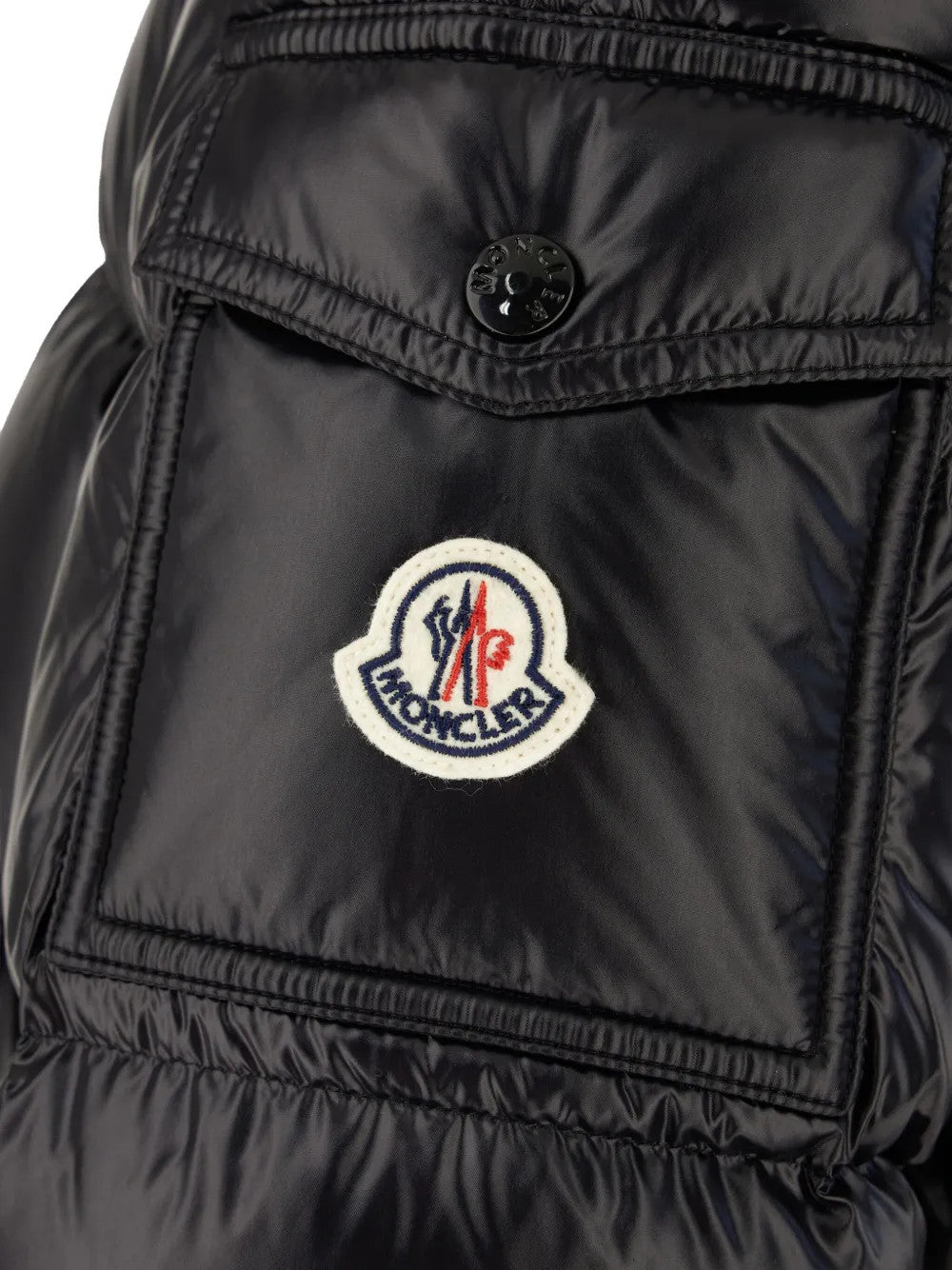 Close up of Black jacket, showing texture of the 100% nylon fabric