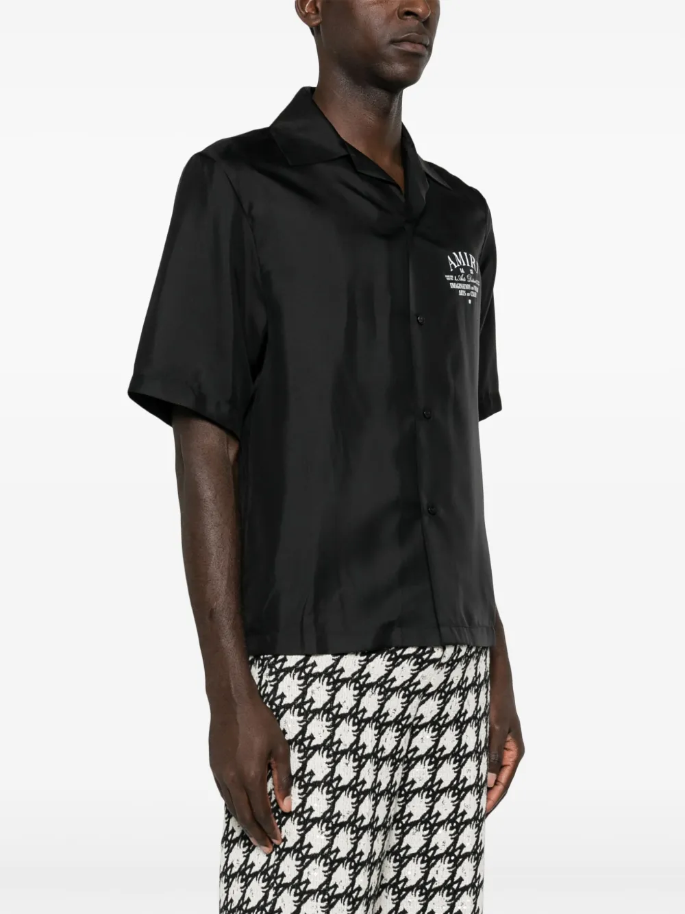 Black shirts worn by a person, showing the shirt's fit